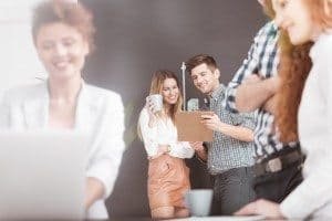 Young team working on creative business project, woman using laptop