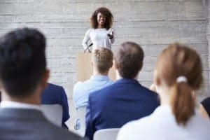 Businesswoman Addressing Delegates At Conference