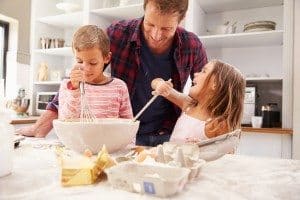 Father baking with children. Having fun
