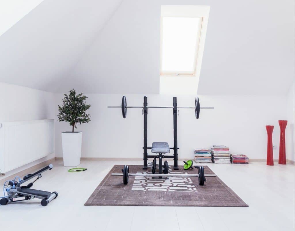 Small gym arranged in white room at home
